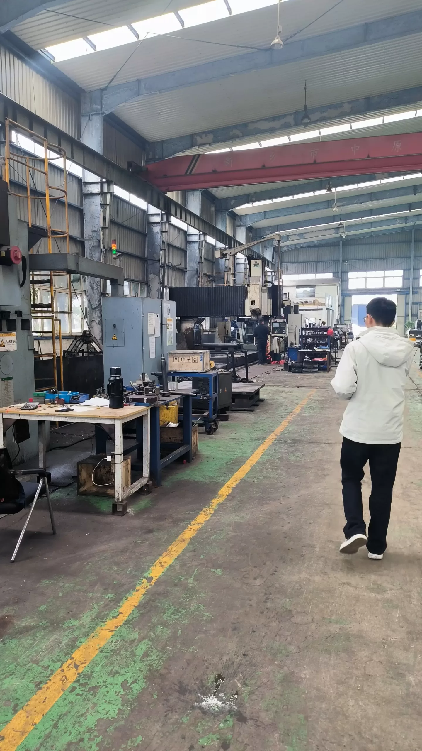 sourcing agent leo walking in a hydraulic factory